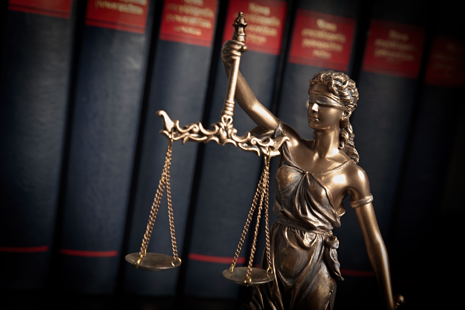 Statue of justice on books background